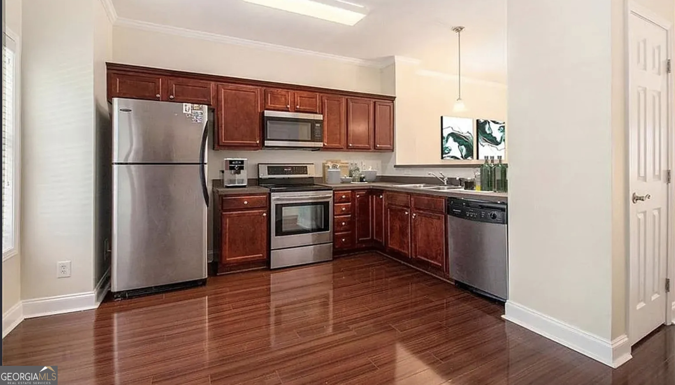 3068 Lauren Parc Road Decatur, GA 30032 - Photo 2 of 12 a kitchen with stainless steel appliances granite countertop a stove top oven a refrigerator and a sink with wooden floor