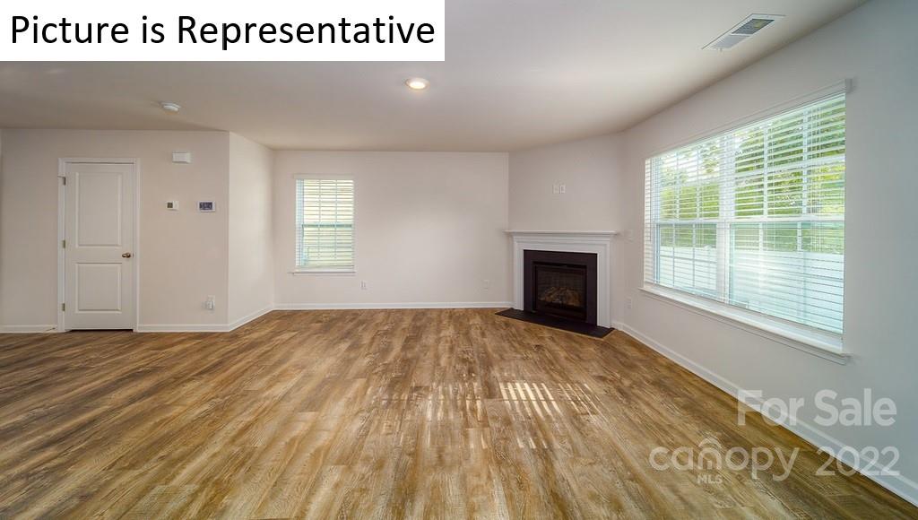 5023 Fandango Road York, SC 29745 - Photo 4 of 30 a view of an empty room with wooden floor and a window