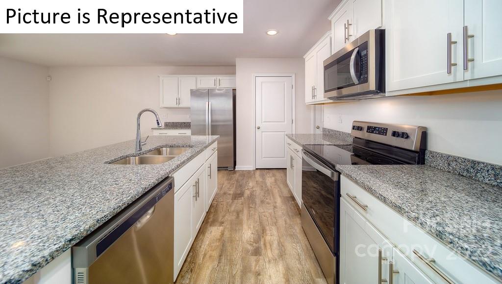 5023 Fandango Road York, SC 29745 - Photo 8 of 30 a kitchen with stainless steel appliances granite countertop a sink stove and refrigerator