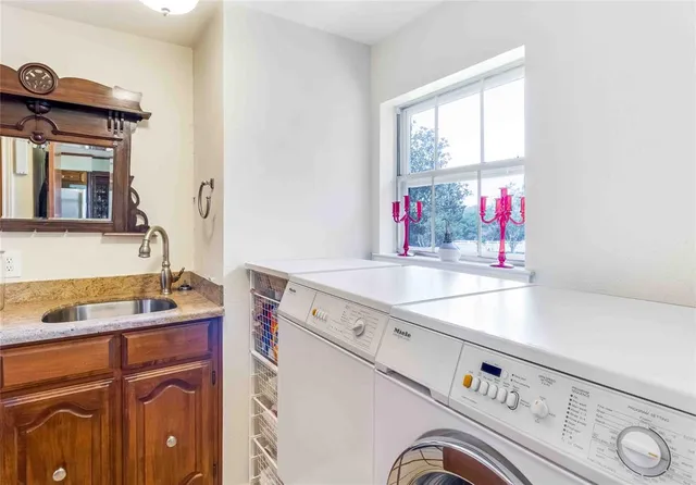 a kitchen with stainless steel appliances granite countertop a sink and a refrigerator