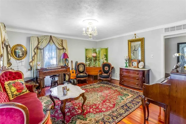 a living room with furniture a rug and a chandelier