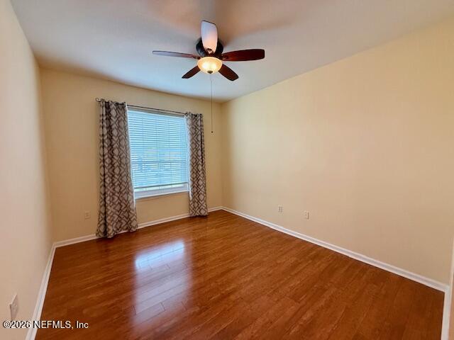7990 Baymeadows Road East, Unit 928 Jacksonville, FL 32256 - Photo 12 of 30 an empty room with wooden floor fan and windows