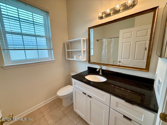 7990 Baymeadows Road East, Unit 928 Jacksonville, FL 32256 - Photo 18 of 30 a bathroom with a sink a toilet and a mirror