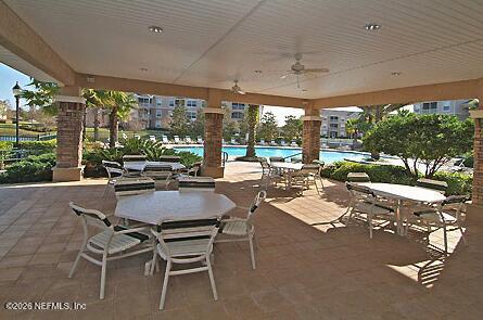7990 Baymeadows Road East, Unit 928 Jacksonville, FL 32256 - Photo 27 of 30 a dining room with furniture and a garden