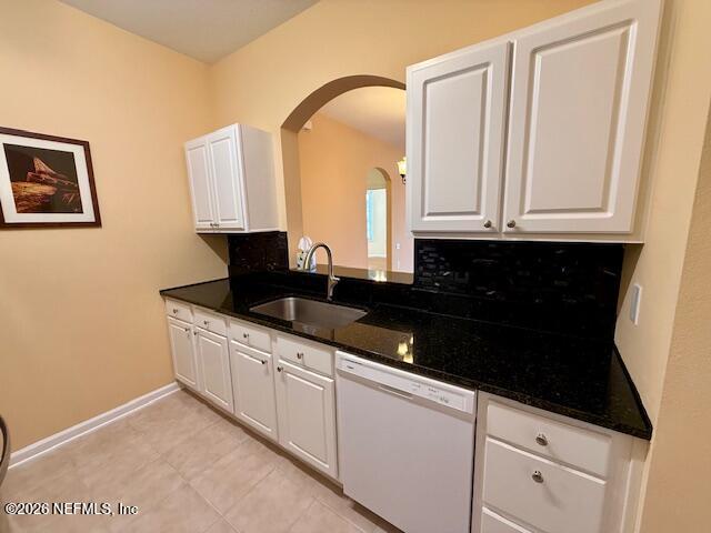 7990 Baymeadows Road East, Unit 928 Jacksonville, FL 32256 - Photo 6 of 30 a kitchen with granite countertop white cabinets and black appliances