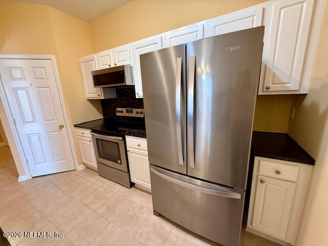 7990 Baymeadows Road East, Unit 928 Jacksonville, FL 32256 - Photo 7 of 30 a kitchen with stainless steel appliances a refrigerator stove and microwave