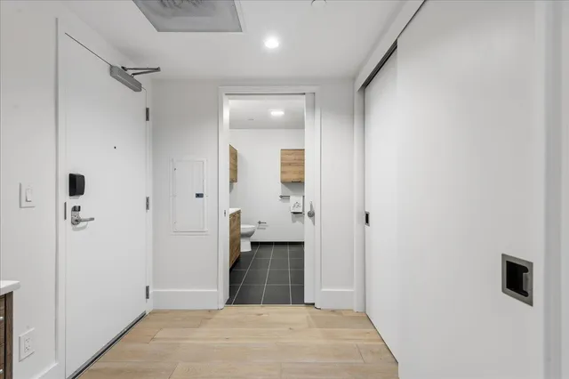 a view of a hallway with a bathroom
