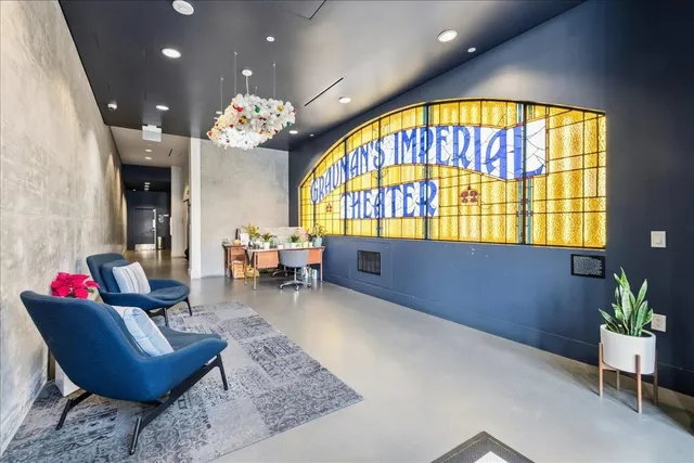 a living room with furniture and a chandelier