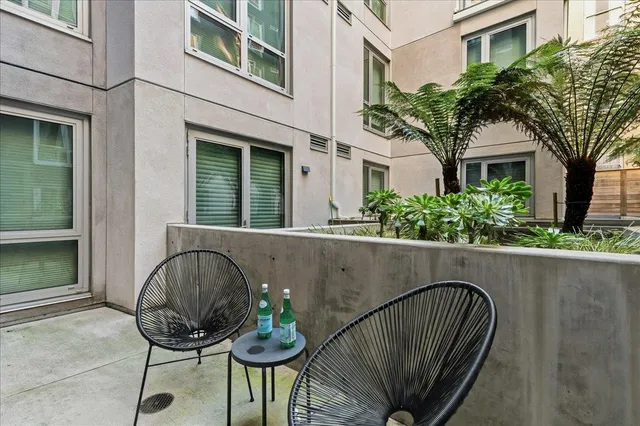 a view of balcony with furniture and potted plants