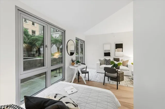 a bedroom with furniture and a window