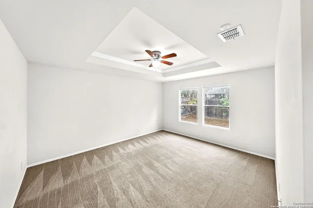 a spacious bedroom with a bed and a window