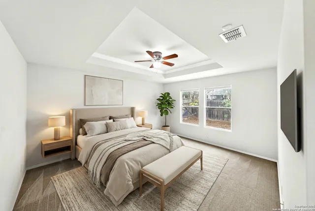 an empty room with fan and windows