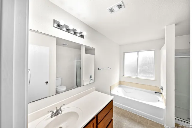 a bathroom with a shower and a glass door