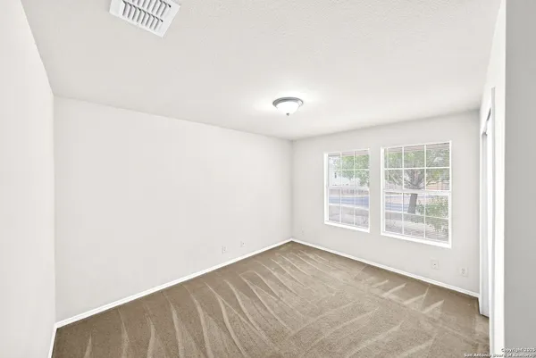 a bedroom with a bed and a potted plant