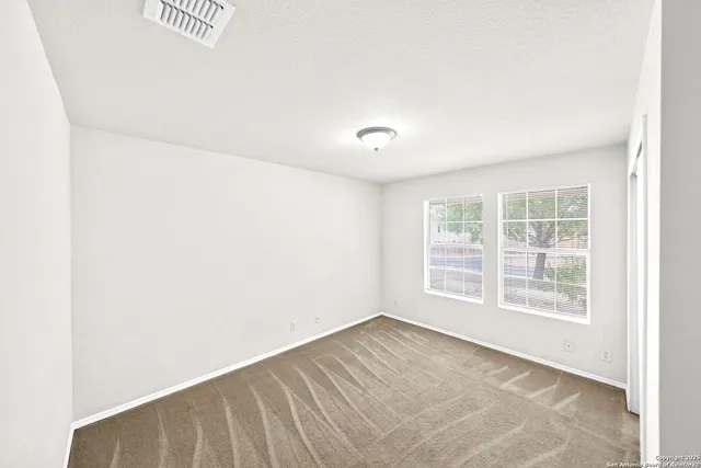 a bedroom with a bed and a potted plant