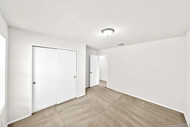 a bedroom with a large bed and a potted plant