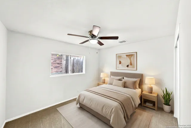 an empty room with a ceiling fan and a window