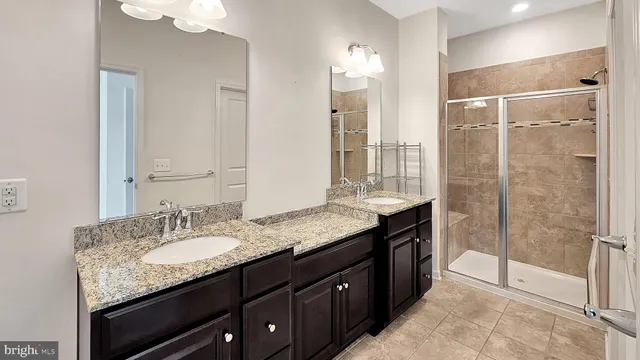 a bathroom with a granite countertop sink mirror and double