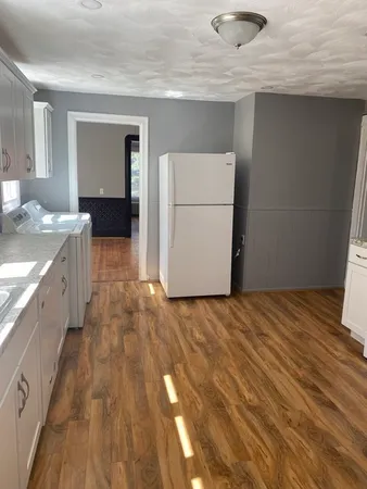 a view of a kitchen cabinets and wooden floor