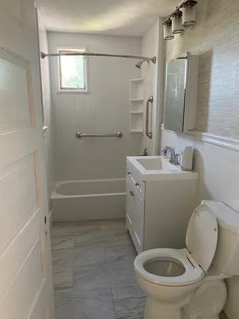 a bathroom with a toilet sink and mirror