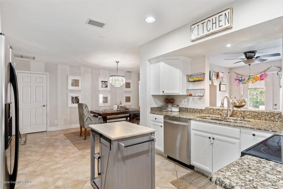 108 Neptune Court Indialantic, FL 32903 - Photo 17 of 33 a kitchen with a sink stove and refrigerator