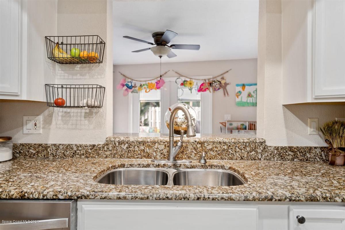 108 Neptune Court Indialantic, FL 32903 - Photo 19 of 33 a kitchen with a sink and a stove