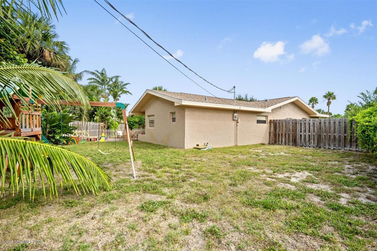 108 Neptune Court Indialantic, FL 32903 - Photo 31 of 33 a backyard of a house with a garden and plants