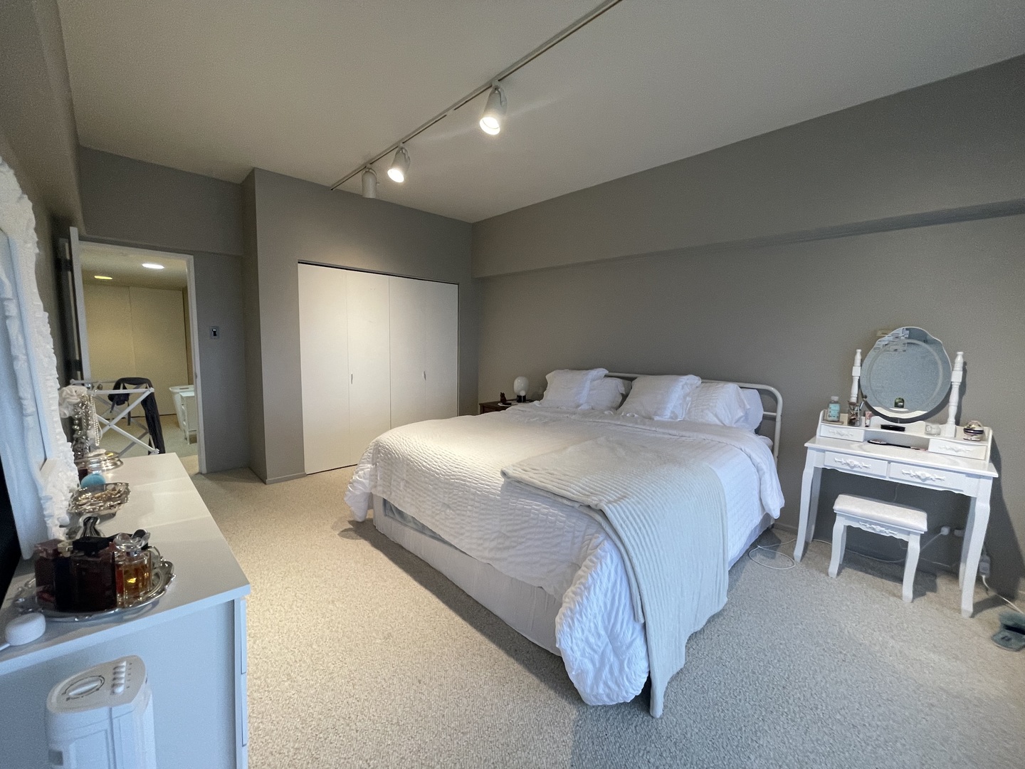 175 East Delaware Place, Unit 4503 Chicago, IL 60611 - Photo 13 of 26 a bedroom with a bed and a chandelier