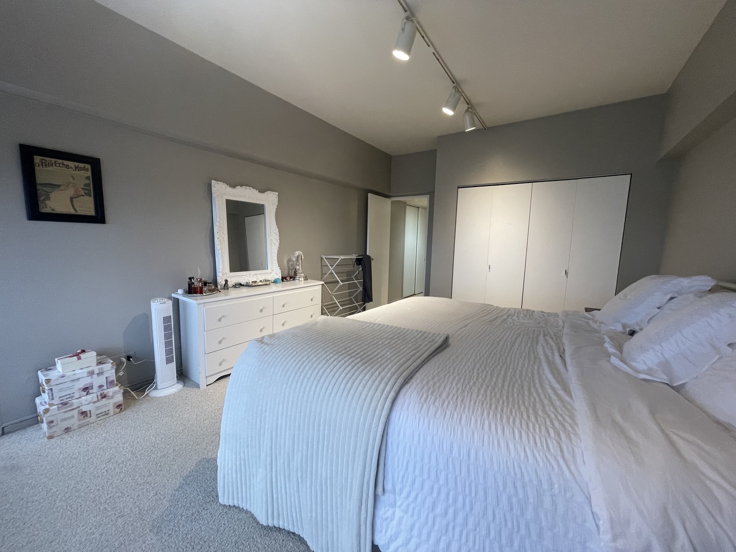 175 East Delaware Place, Unit 4503 Chicago, IL 60611 - Photo 14 of 26 a spacious bedroom with a bed and a mirror