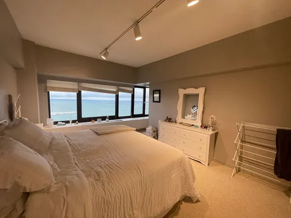 a spacious bedroom with a bed and window
