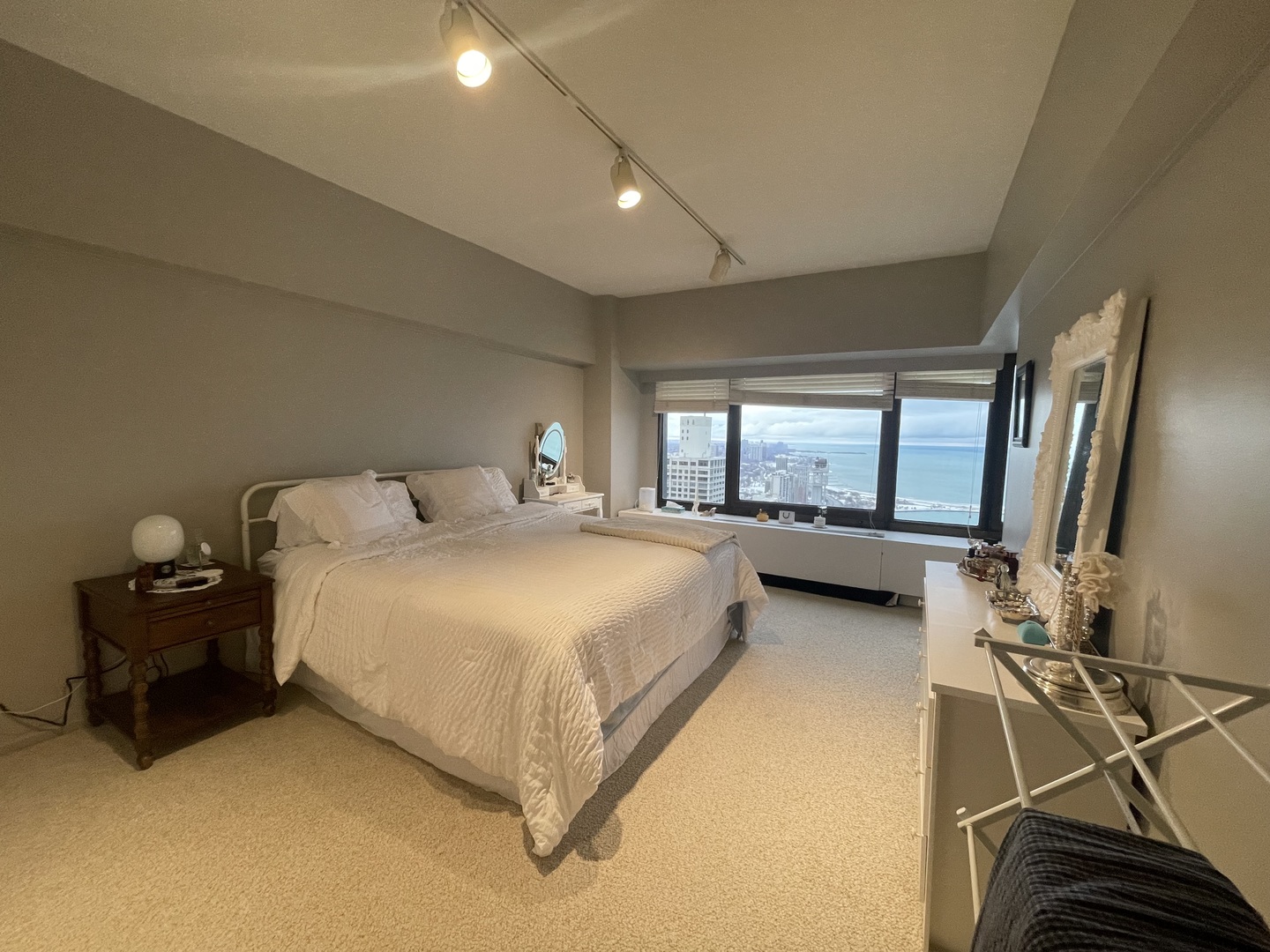 175 East Delaware Place, Unit 4503 Chicago, IL 60611 - Photo 16 of 26 a spacious bedroom with a bed and window