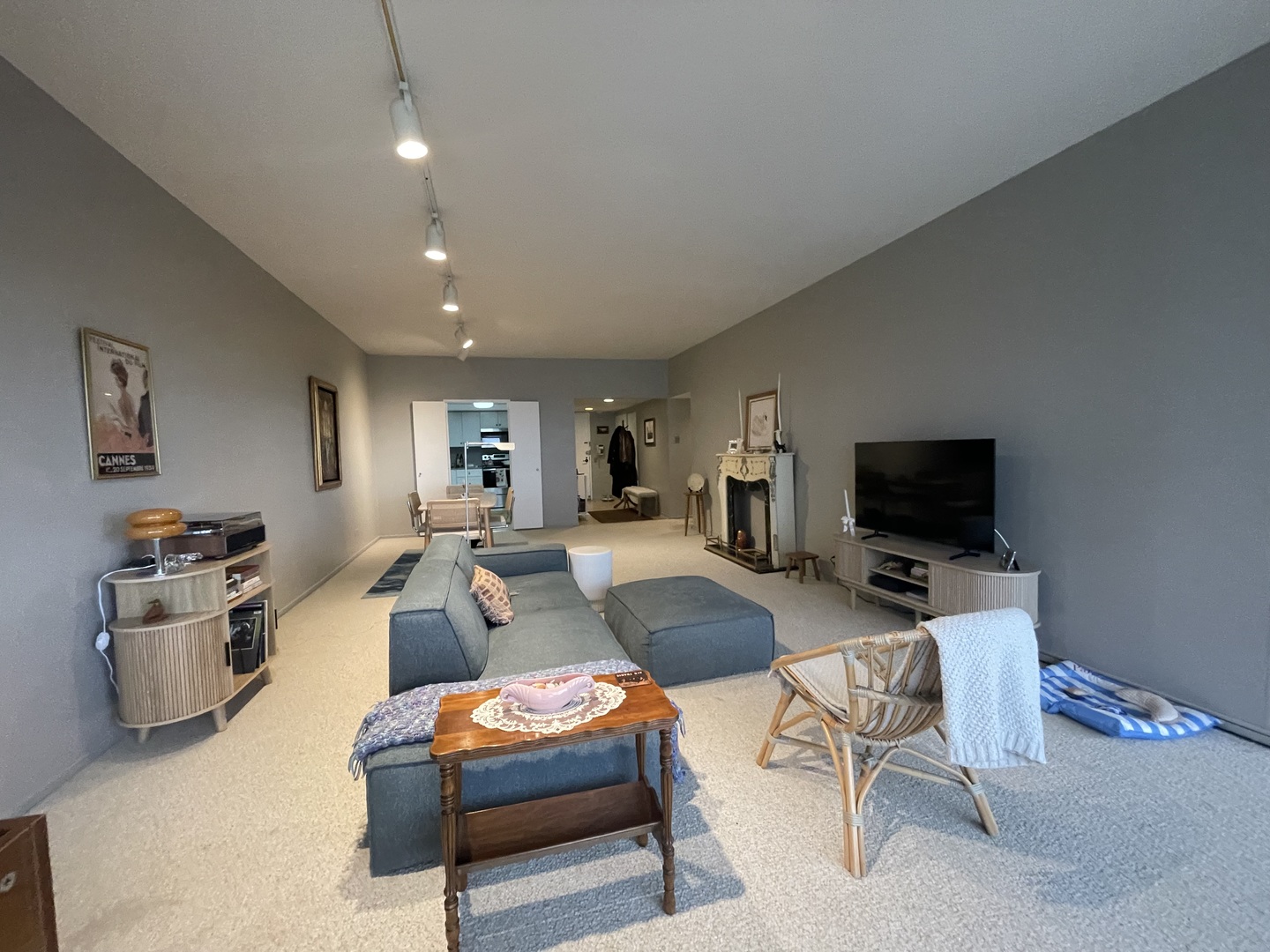 175 East Delaware Place, Unit 4503 Chicago, IL 60611 - Photo 6 of 26 a living room with furniture a flat screen tv and a refrigerator