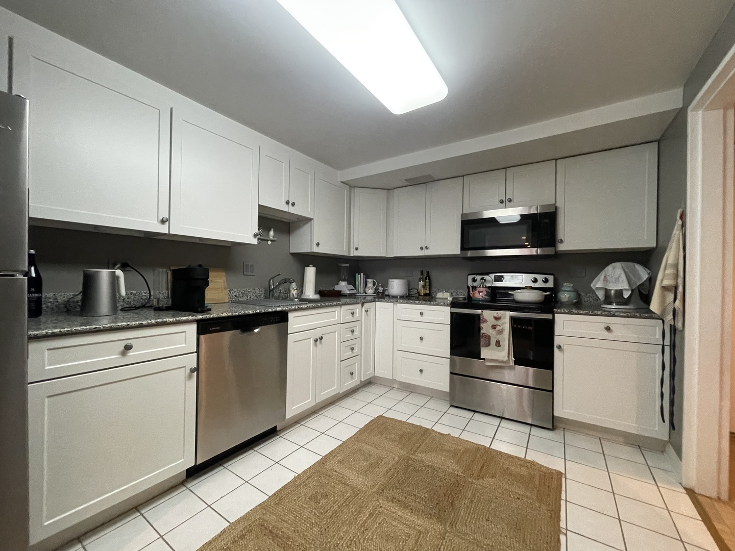 175 East Delaware Place, Unit 4503 Chicago, IL 60611 - Photo 7 of 26 a kitchen with granite countertop a sink a stove and cabinets