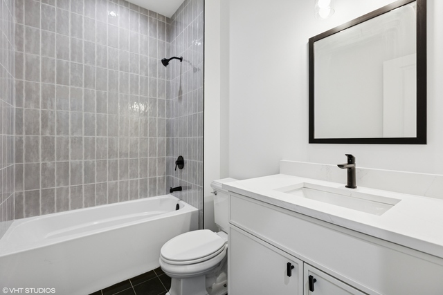 3219 North Elston Avenue, Unit 3 Chicago, IL 60618 - Photo 9 of 13 a bathroom with a sink a toilet and shower