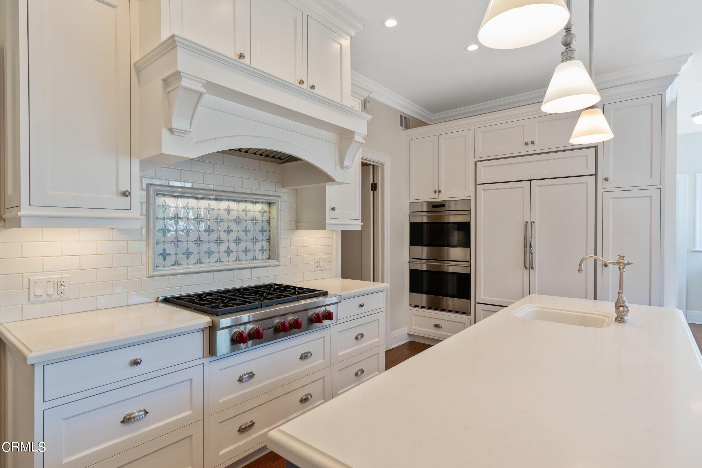 625 Cumberland Road Glendale, CA 91202 - Photo 42 of 73 a kitchen with white cabinets and appliances