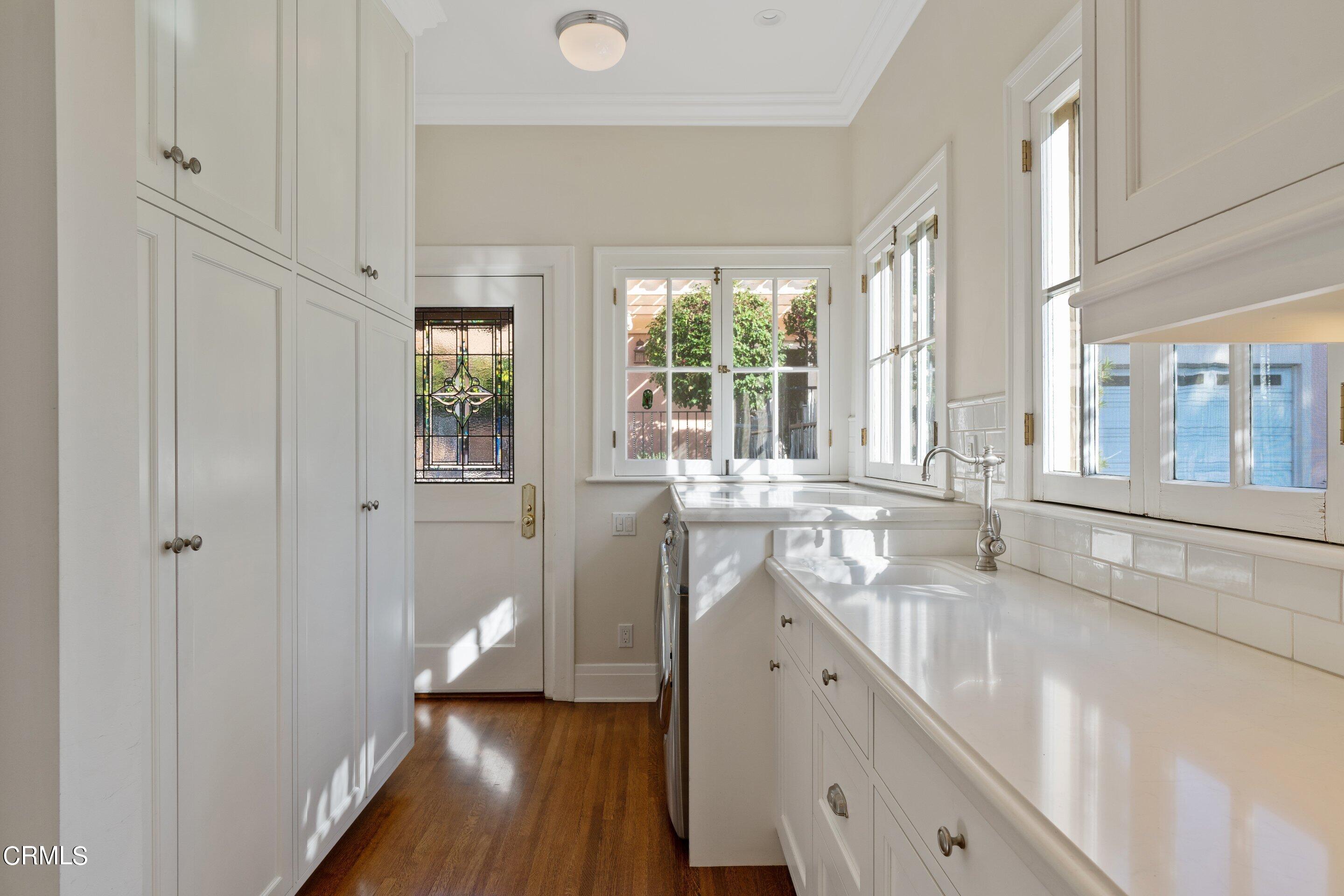 625 Cumberland Road Glendale, CA 91202 - Photo 43 of 73 a bathroom with a granite countertop sink and a large window