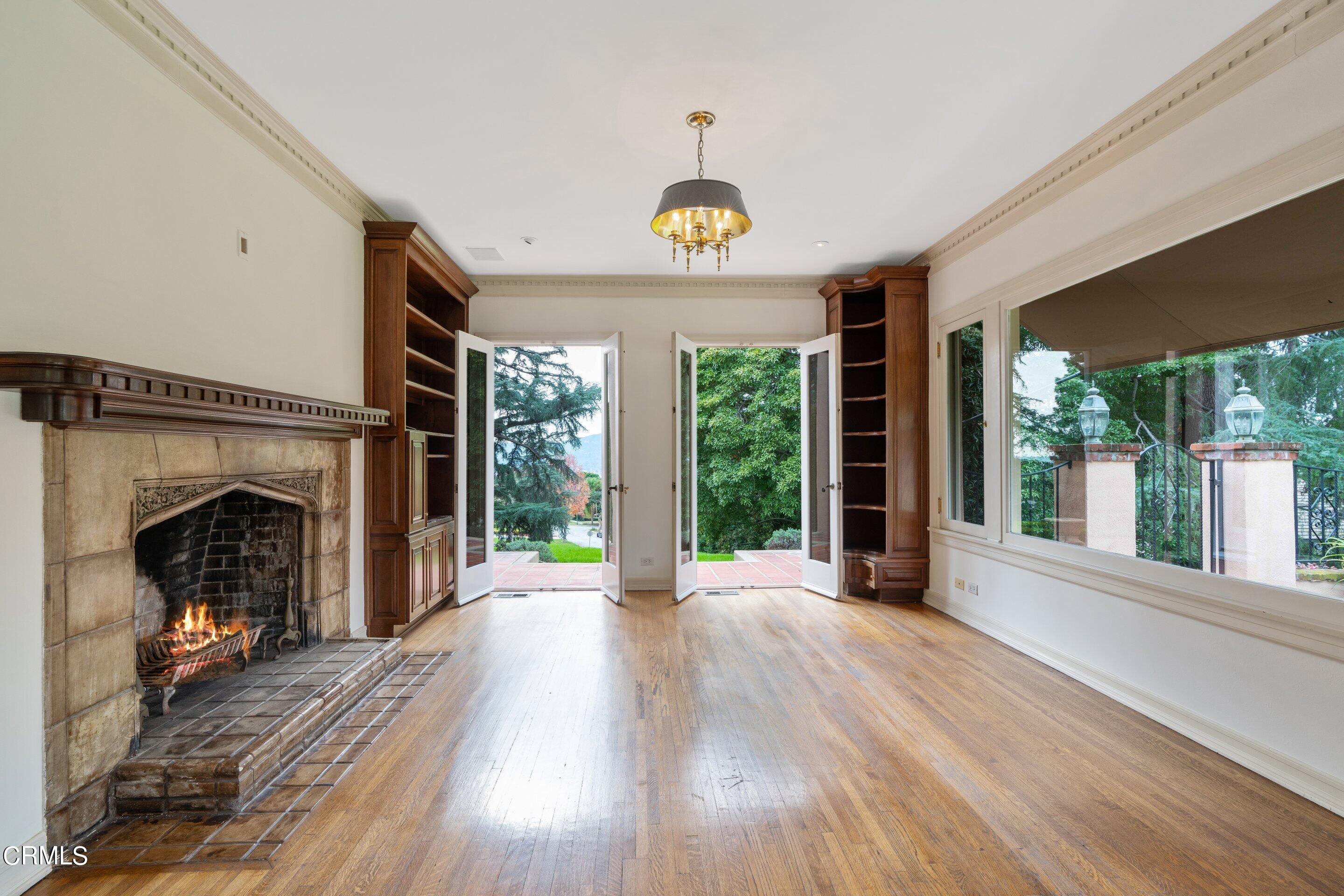 625 Cumberland Road Glendale, CA 91202 - Photo 45 of 73 a view of an empty room with wooden floor fireplace and a window