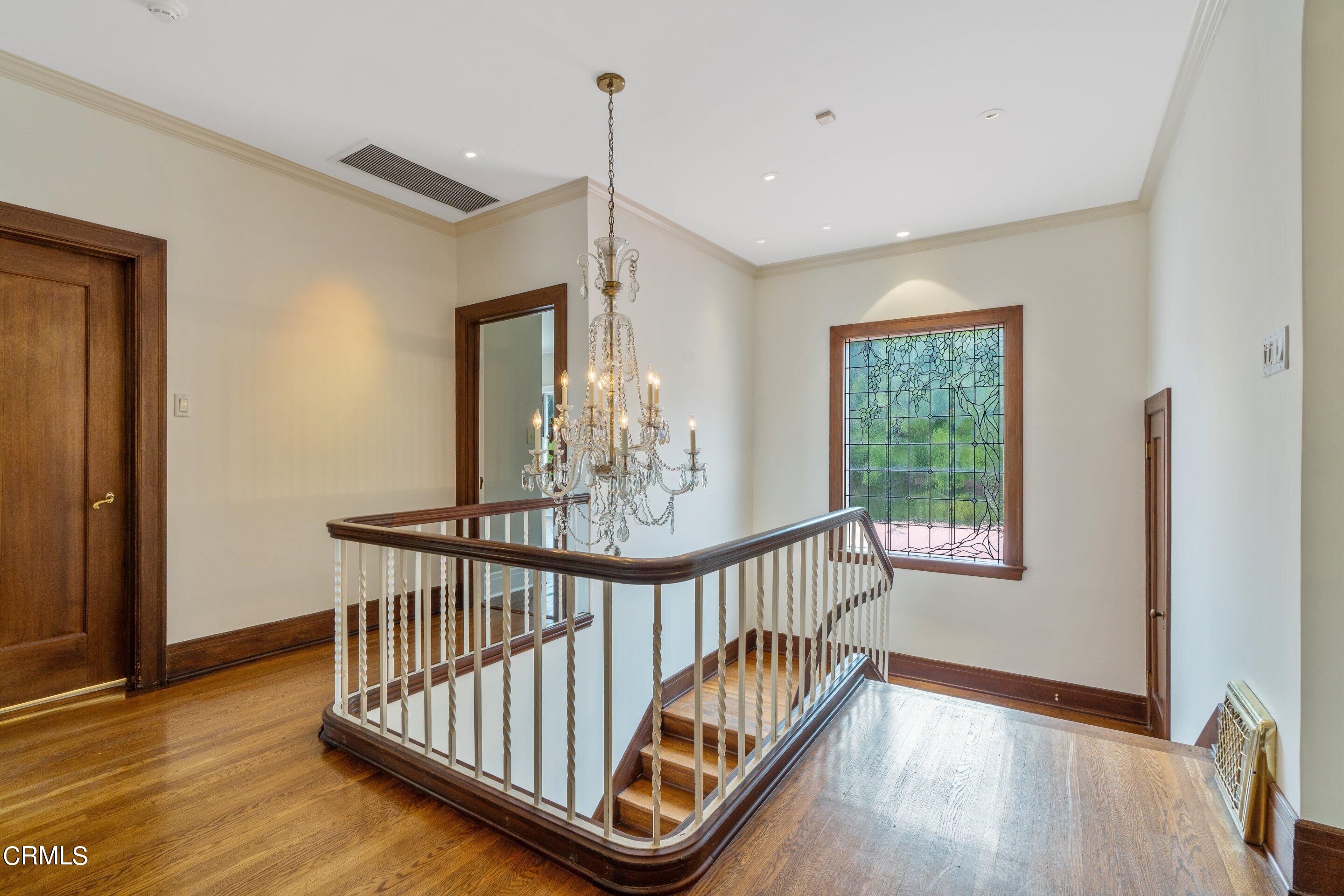 625 Cumberland Road Glendale, CA 91202 - Photo 50 of 73 a view of a hallway with wooden floor and windows