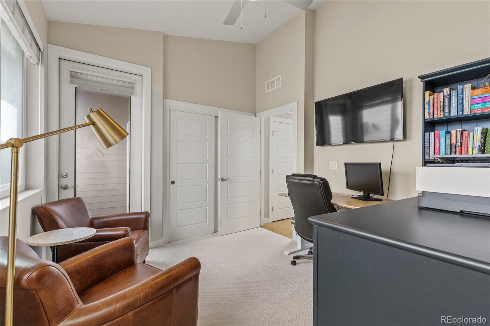 3553 South Emerson Street, Unit 2 Englewood, CO 80113 - Photo 16 of 31 a living room with furniture a flat screen tv and a fireplace
