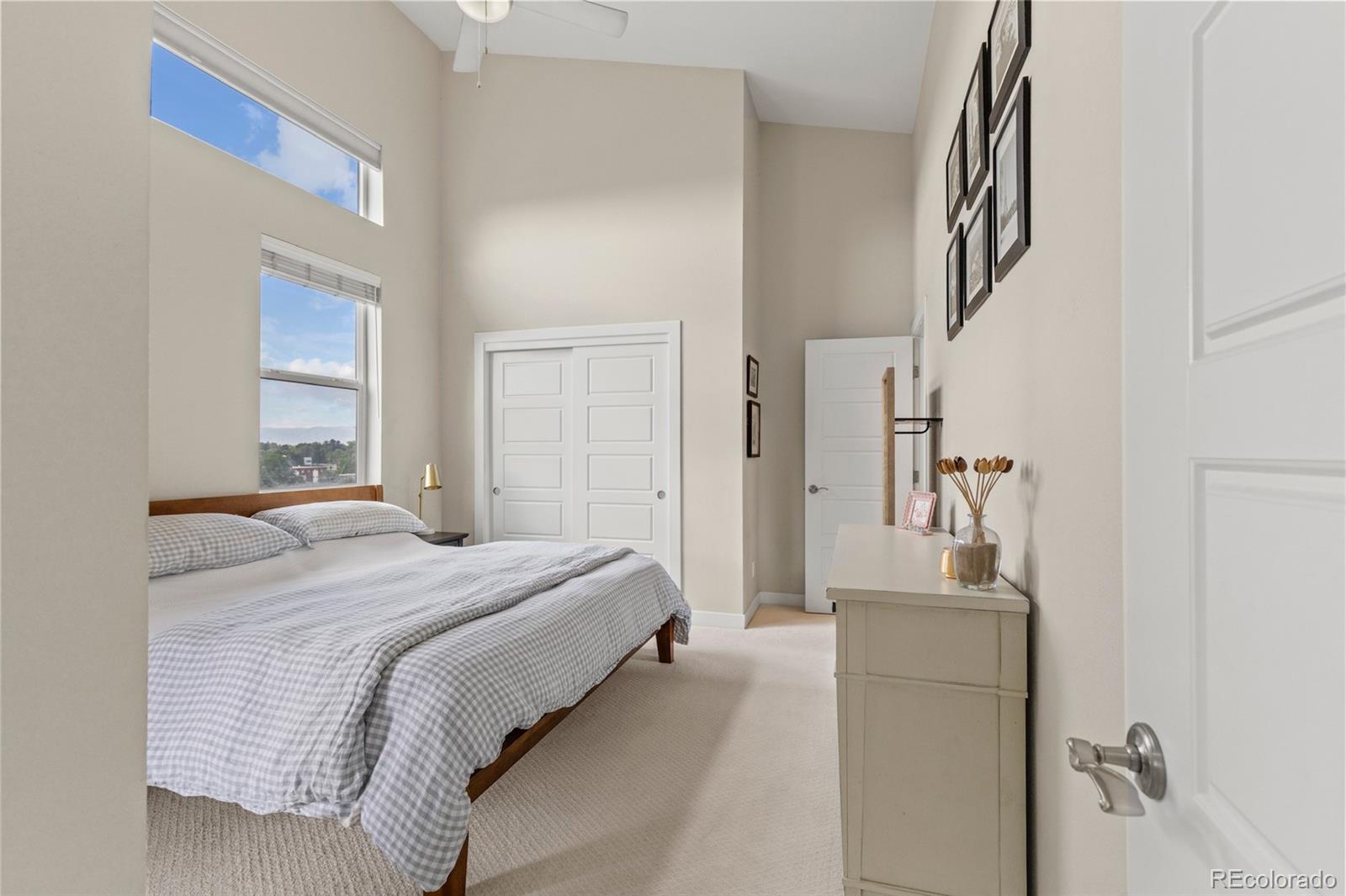 3553 South Emerson Street, Unit 2 Englewood, CO 80113 - Photo 19 of 31 a bedroom with a bed and a mirror