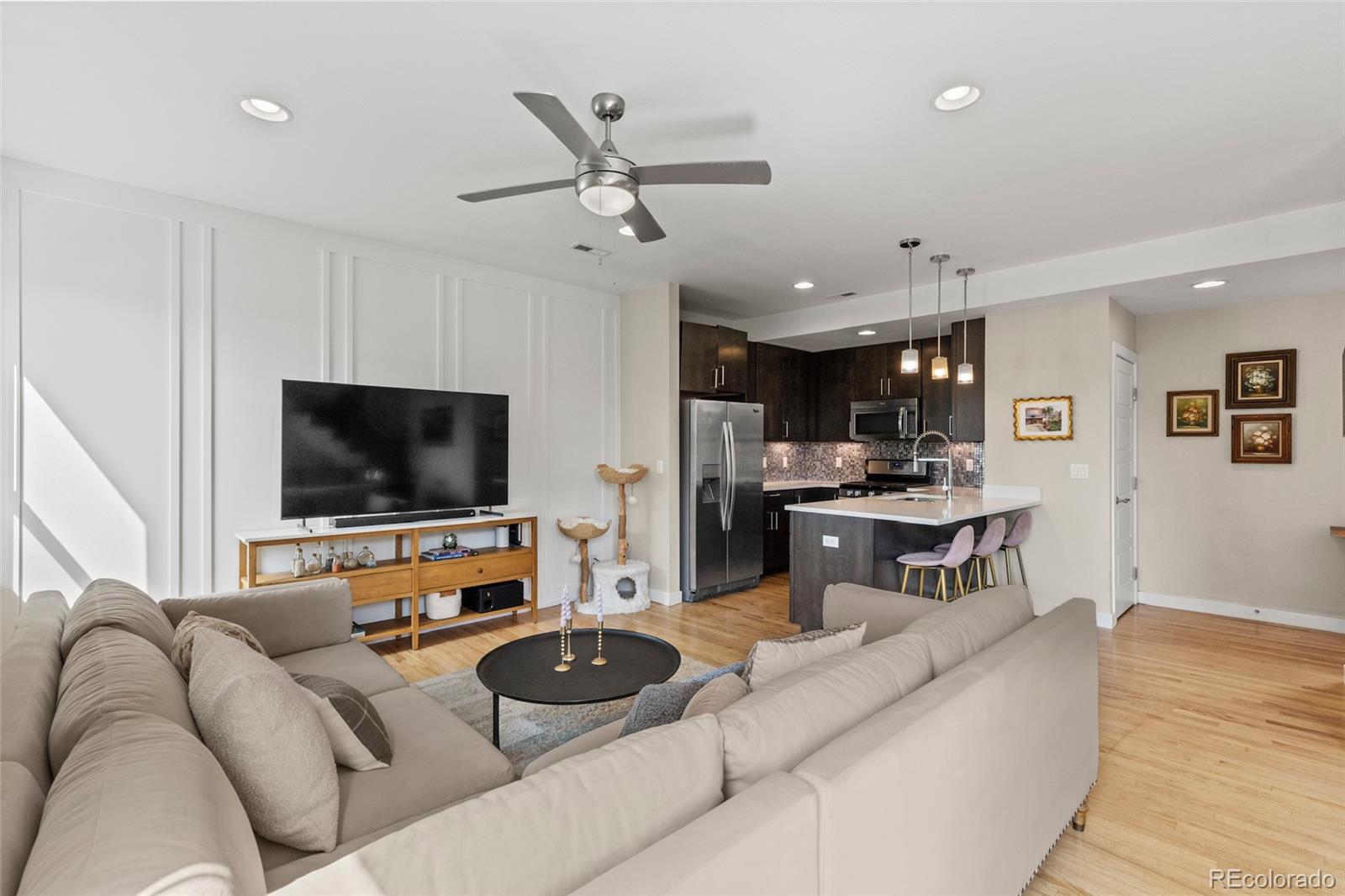 3553 South Emerson Street, Unit 2 Englewood, CO 80113 - Photo 2 of 31 a living room with furniture and a flat screen tv