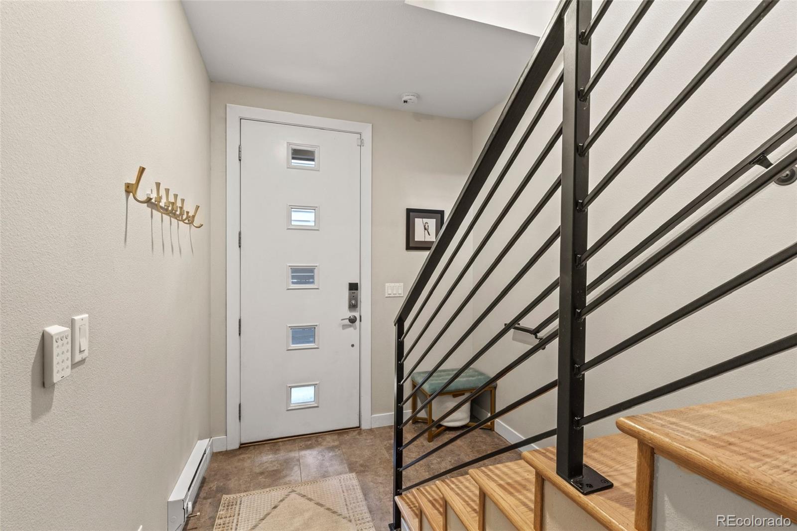 3553 South Emerson Street, Unit 2 Englewood, CO 80113 - Photo 27 of 31 a view of an entryway with wooden floor and stairs