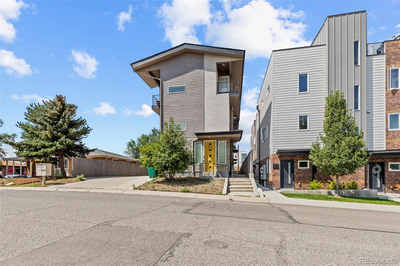 3553 South Emerson Street, Unit 2 Englewood, CO 80113 - Photo 28 of 31 a front view of a house with a yard and garage