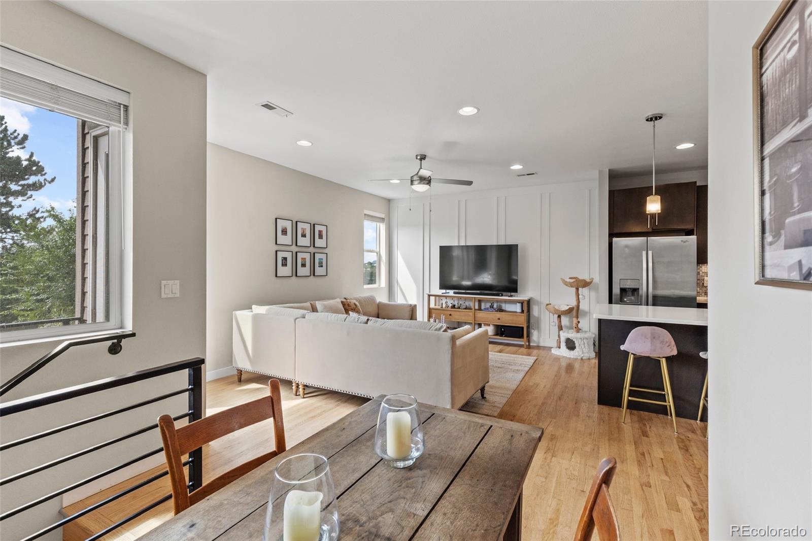 3553 South Emerson Street, Unit 2 Englewood, CO 80113 - Photo 3 of 31 a living room with furniture a flat screen tv and a large window