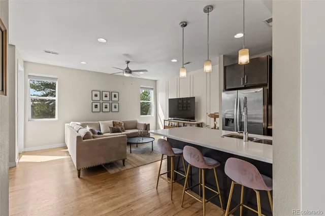 a living room with furniture a window and a flat screen tv