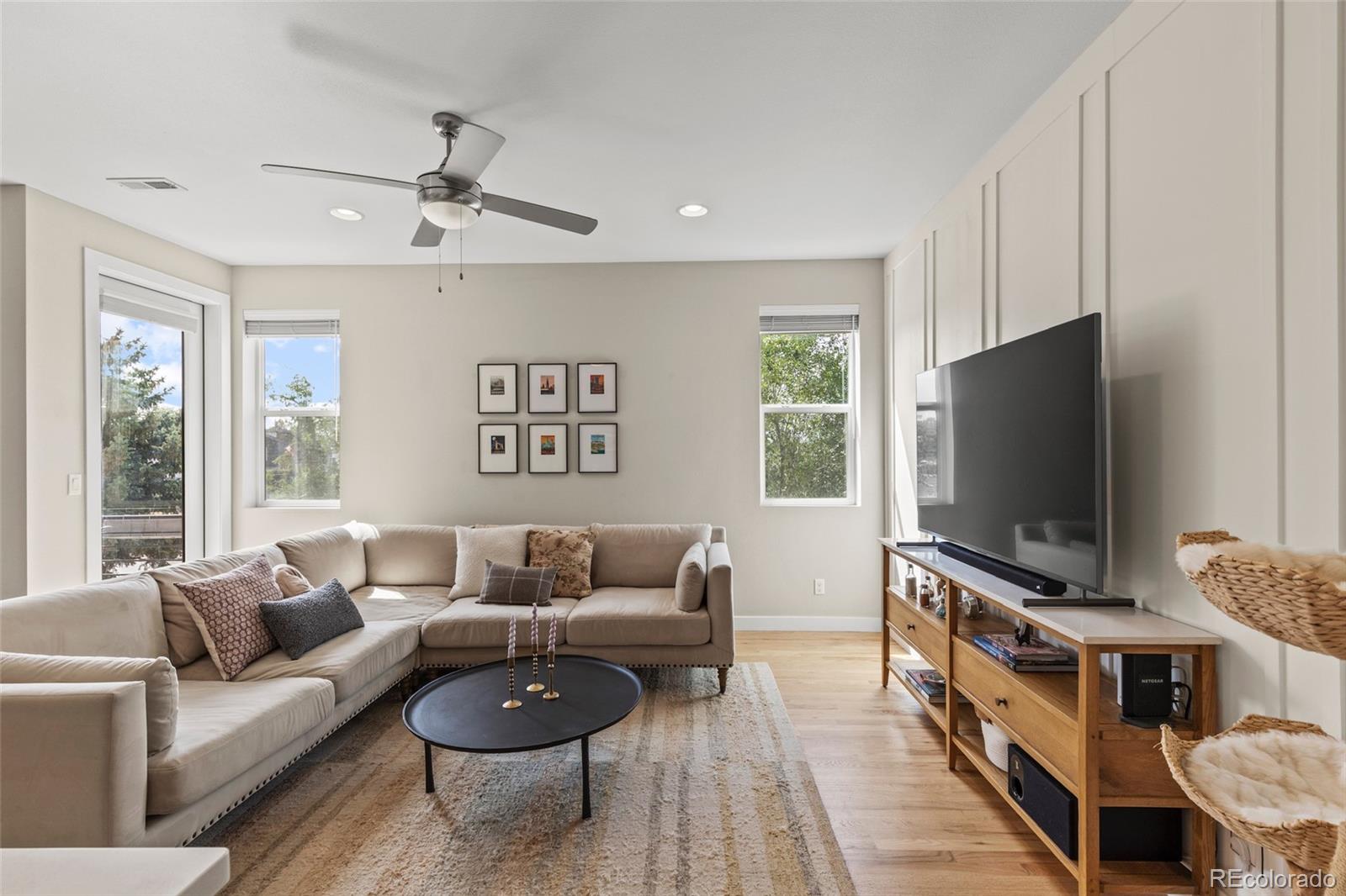 3553 South Emerson Street, Unit 2 Englewood, CO 80113 - Photo 5 of 31 a living room with furniture and a flat screen tv