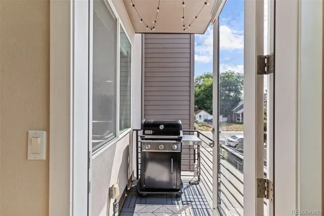 a view of a hallway with a door and wooden floor