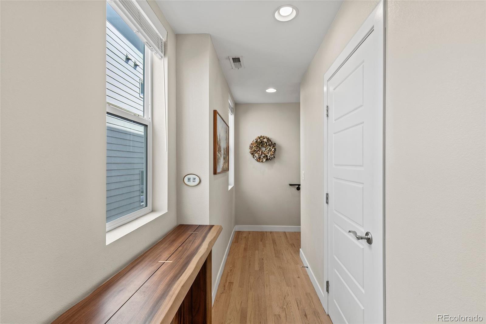 3553 South Emerson Street, Unit 2 Englewood, CO 80113 - Photo 8 of 31 a view of a hallway with wooden floor and staircase