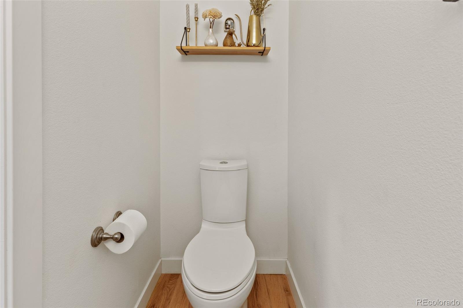 3553 South Emerson Street, Unit 2 Englewood, CO 80113 - Photo 9 of 31 a white toilet sitting next to a white wall