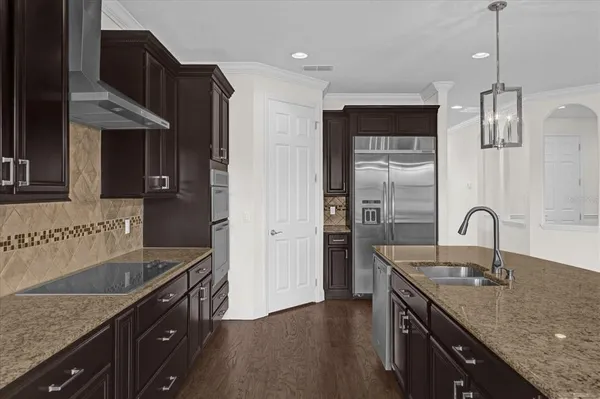 a kitchen with a sink and wooden cabinets